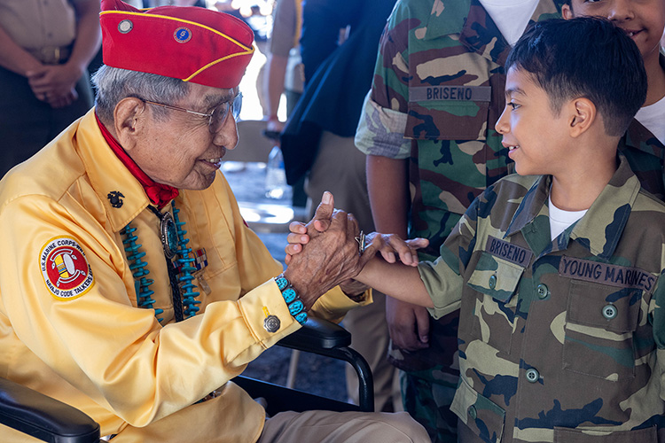 U.S. Marine Corps Navajo Code Talker veteran, Cpl. Peter Macdonald, former Navajo Nation Chairman, engages with members of the Young Marines program.