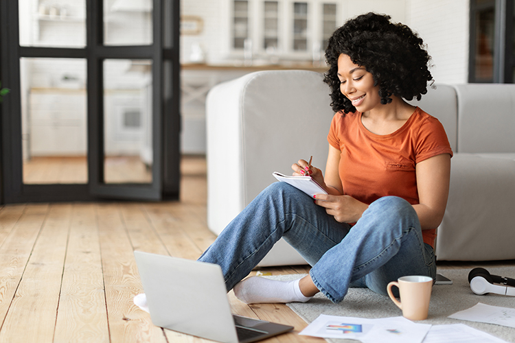 Young Female Using Laptop At Home